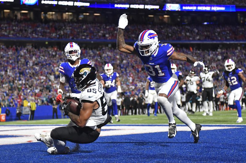 Jacksonville Jaguars tight end Brenton Strange (85) makes a touchdown catch past Buffalo Bills cornerback Rasul Douglas (31) during the second half of an NFL football game Monday, Sept. 23, 2024, in Orchard Park, NY. (AP Photo/Adrian Kraus)