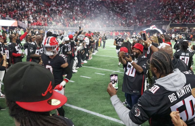 Hip Hop artists take the field to form a tunnel for the entrance of the Atlanta Falcons. The Falcons celebrated Hip-Hop 50 with performances and appearances during their NFL football game between the Atlanta Falcons and the New Orleans Saints in Atlanta on Sunday, Nov. 26, 2023.   (Bob Andres for the Atlanta Journal Constitution)