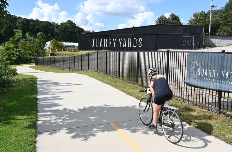 A bicyclist peddles past Quarry Yards on the Proctor Creek Greenway near Bankhead MARTA Station on Saturday, September 12, 2020. The 70 acres was put together by former Georgia Tech and Atlanta Braves baseball star Mark Teixeira and his partners. It was slated for a highly publicized mixed-use development in a low-income area that is drawing intense interest from developers. The land is at the convergence of three of Atlanta’s highly touted greenspace initiatives under development — Bellwood Quarry Park, the Beltline and the Proctor Creek Greenway. (Hyosub Shin / Hyosub.Shin@ajc.com)