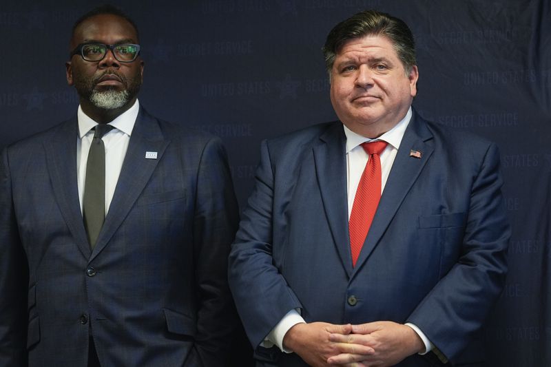 Illinois Gov. JB Pritzker, right, stands with Chicago Mayor Brandon Johnson during a Democratic National Convention security briefing at the U.S. Secret Service's Chicago Field Office Thursday, July 25, 2024, in Chicago. (AP Photo/Erin Hooley)