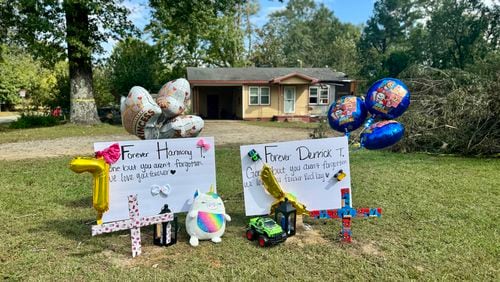 Memorial placards to Harmony Taylor, 7, and Derrick Taylor, 4, who were killed when a tree crashed down on their house on South Hospital Road in Sandersville, Georgia early Friday. (Joe Kovac Jr. / AJC)