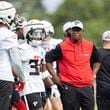 Falcons coach Raheem Morris watches practice during training camp at the Falcons’ headquarters in Flowery Branch on Friday, July 26, 2024. (Arvin Temkar / AJC)
