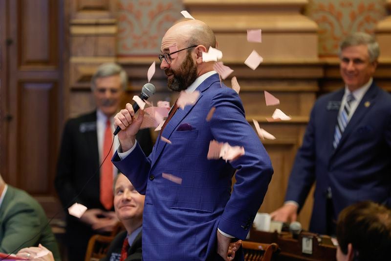 Sen. Josh McLaurin (D-Sandy Springs) gets paper thrown on him by Sen. John Albers (R-Roswell) as he makes an early motion to adjourn early on Sine Die at the State Capitol on Wednesday, March 29, 2023.  (Natrice Miller/The Atlanta Journal-Constitution)