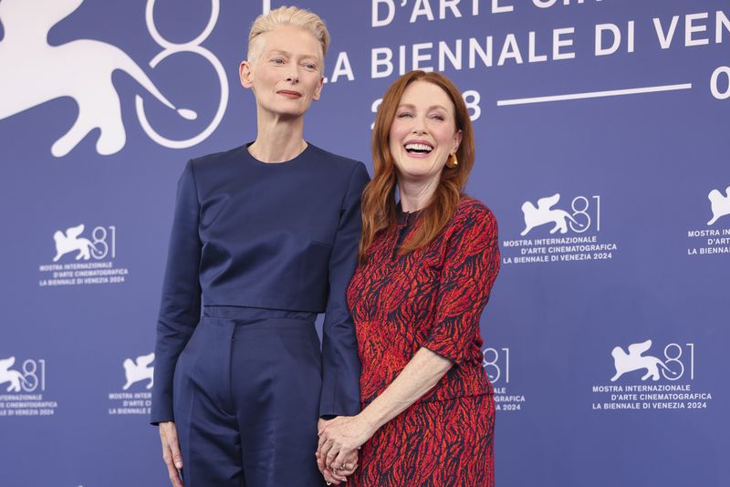 Tilda Swinton, left, and Julianne Moore pose for photographers at the photo call for the film 'The Room Next Door' during the 81st edition of the Venice Film Festival in Venice, Italy, on Monday, Sept. 2, 2024. (Photo by Vianney Le Caer/Invision/AP)