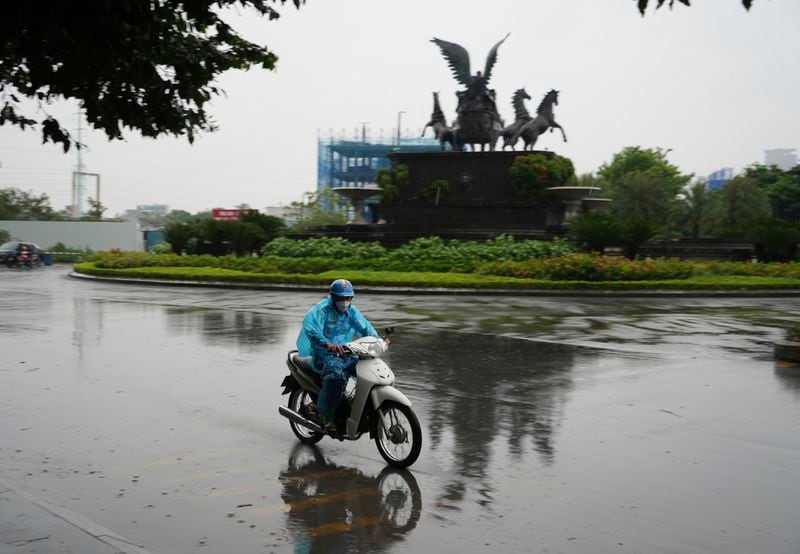 A man rides motorcycle in the rain caused by typhoon Yagi in Hanoi, Vietnam Saturday, Sept. 7, 2024. (AP Photo/Hau Dinh)