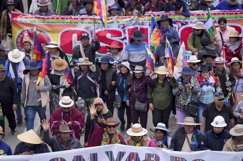 Former President Evo Morales, third from left in the front row, marches to the capital with supporters to protest the government of current President Luis Arce, near El Alto, Bolivia, Sunday, Sept. 22, 2024. (AP Photo/Juan Karita)