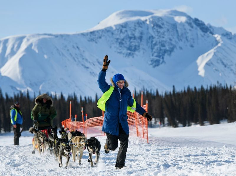 The scenery is not too shabby as Sean Underwood and his dog team follow a volunteer to park at the Finger Lake checkpoint.  (Marc Lester / Anchorage Daily News)