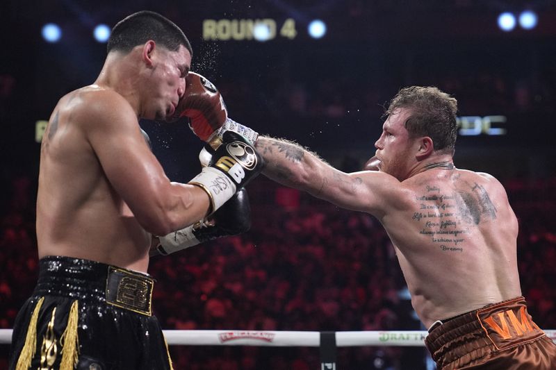 Canelo Alvarez hits Edgar Berlanga in a super middleweight title bout Saturday, Sept. 14, 2024, in Las Vegas. (AP Photo/John Locher)