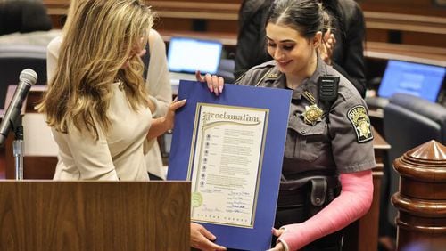 Detention Officer Brooklyn Unitas receives a proclamation from Fulton County Commissioner Bridget Thorne, declaring May 3 as Detention Officer Brooklyn Unitas Appreciation Day. Unitas was injured April 7 when attacked by an inmate in the jail's mental health unit.