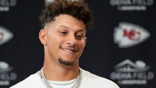 Kansas City Chiefs quarterback Patrick Mahomes smiles during a news conference following an NFL football game against the Baltimore Ravens Thursday, Sept. 5, 2024, in Kansas City, Mo. The Chiefs won 27-20. (AP Photo/Charlie Riedel)