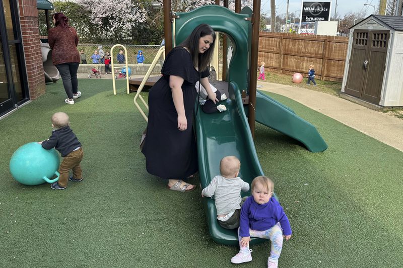 FILE - Delaney Griffin, center, plays with toddlers at the child care center where she works, March 13, 2024, in Lexington, Ky. (AP Photo/Dylan Lovan, File)