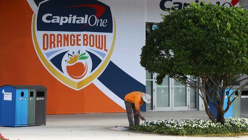122921 Miami Gardens: A worker tends to a flower bed outside Hard Rock Stadium on Wednesday, Dec 29, 2021,  where Georgia will play Michigan in the Orange Bowl CFP Semifinal in Miami Gardens.   “Curtis Compton / Curtis.Compton@ajc.com”`