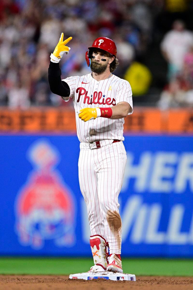 Philadelphia Phillies' Bryce Harper reacts after hitting a double off Atlanta Braves' Spencer Schwellenbach during the sixth inning of a baseball game, Sunday, Sept. 1, 2024, in Philadelphia. (AP Photo/Derik Hamilton)