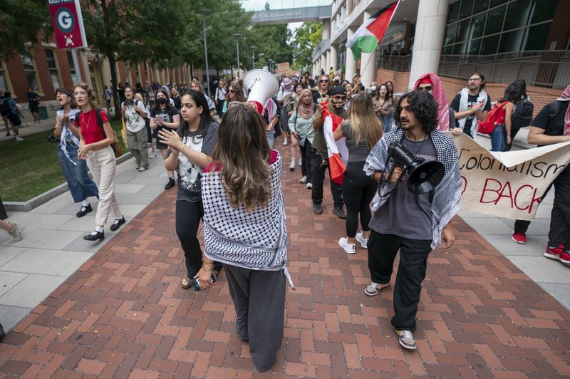 Alia Amanpour Trapp, center, leads the crowd during a pro-Palestine rally and march on Temple University campus in Philadelphia, Aug. 29, 2024. (AP Photo/Chris Szagola)