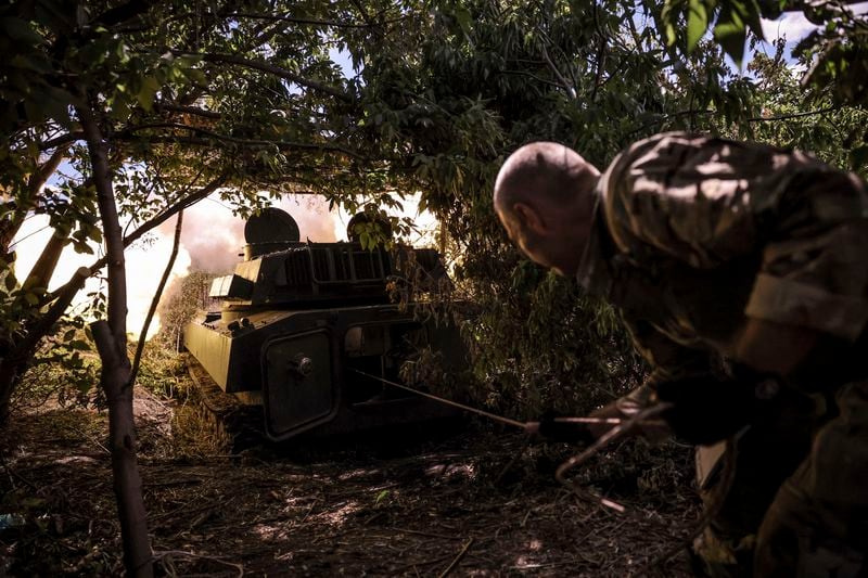 In this photo provided by Ukraine's 24th Mechanised Brigade press service, a soldier fires a "Gvozdika" 120mm Soviet-made howitzer towards Russian positions at outskirts of Chasiv Yar, Donetsk region, Ukraine, Saturday, June 22, 2024, (Oleg Petrasiuk/Ukraine's 24th Mechanised Brigade via AP)