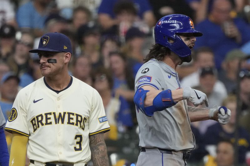 New York Mets' Jesse Winker reacts in front of Milwaukee Brewers third base Joey Ortiz after hitting a two-run scoring triple during the second inning of Game 2 of a National League wild card baseball game Tuesday, Oct. 1, 2024, in Milwaukee. (AP Photo/Morry Gash)