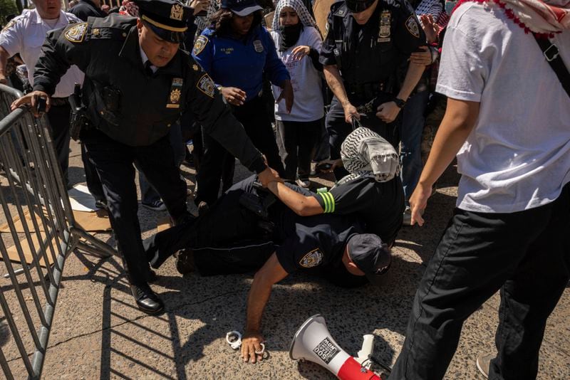 NYPD officers detain a pro-Palestinian supporter as they hold picket line outside Barnard College, Tuesday, Sept. 3, 2024, in New York. (AP Photo/Yuki Iwamura)