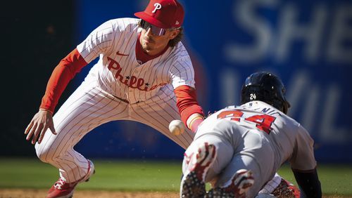Philadelphia Phillies' Bryson Stott tags out Atlanta Braves' Jarred Kelenic attempting steal second during the third inning of an opening day baseball game, Friday, March 29, 2024, in Philadelphia. (AP Photo/Matt Slocum)