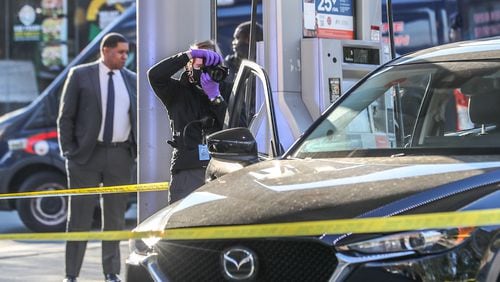 Atlanta police investigate a shooting at a gas station near Mercedes-Benz Stadium on Tuesday morning. (John Spink / John.Spink@ajc.com)