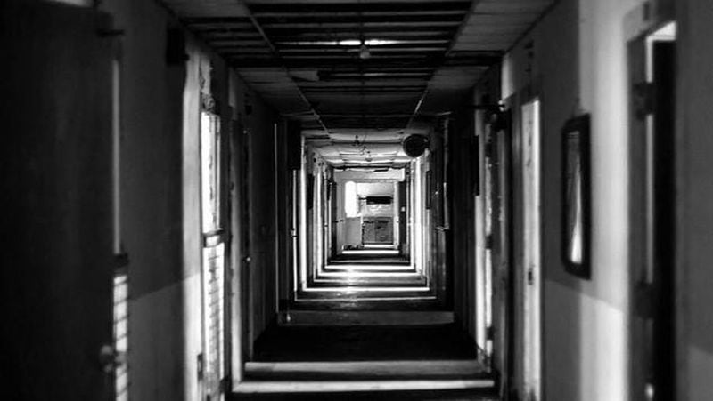 An interior photo of the old Yorktown Memorial Hospital shows a chillingly shadowed corridor.