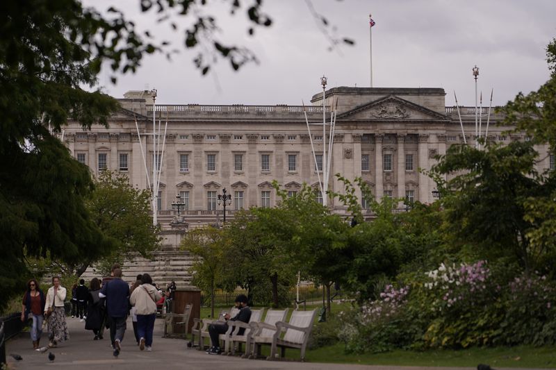 Tourists take photos and visit Buckingham Palace in London, Tuesday, Sept. 10, 2024. Kate, Princess of Wales announced Monday that she has completed chemotherapy treatment for cancer and plans to return to some public duties. (AP Photo/Alberto Pezzali)