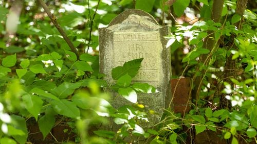 A gravestone of one of Audrey Collins’ relatives in Piney Grove Cemetery in Buckhead on Wednesday, May 3, 2023. Audrey and her sister Rhonda Jackson are trying to restore the ancient cemetery, which is where about 30 of their family members are buried. (Arvin Temkar / arvin.temkar@ajc.com)