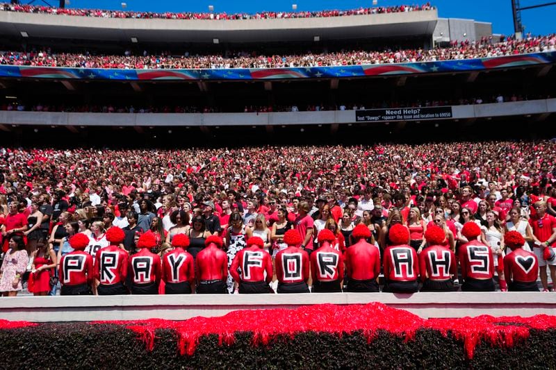 Fans observe a moment of silence for victims of Wednesday's school shooting at Apalachee High School before an NCAA college football game between Tennessee Tech and Georgia Saturday, Sept. 7, 2024, in Athens, Ga. (AP Photo/John Bazemore)