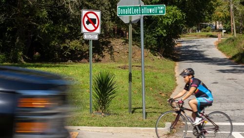 Rolanda Powell rides her bike down Donald Lee Hollowell Parkway in Atlanta, Georgia, on Tuesday, October 13, 2020. Rolanda Powell, head of her neighborhood organization, has been raising concerns about the safety of Donald Lee Hollowell Parkway following several recent fatalities. (Photo/Rebecca Wright for the Atlanta Journal-Constitution)