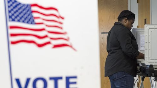 Jujuan Odom, 23, votes at a voting station at the Southwest Branch Library in Atlanta on March 21. (DAVID BARNES / DAVID.BARNES@AJC.COM)