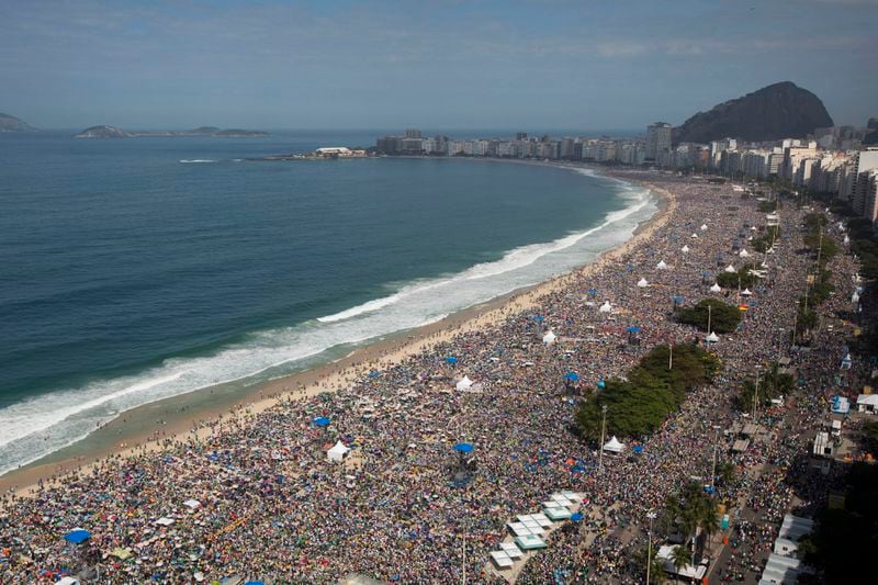 FILE - Crowds line the Copacabana beachfront as they attend the World Youth Day's concluding Mass celebrated by Pope Francis, in Rio de Janeiro, Brazil, on July 28, 2013. Francis wrapped up is historic trip to his home continent Sunday with a Mass that drew a reported 3 million people. (AP Photo/Felipe Dana, File)