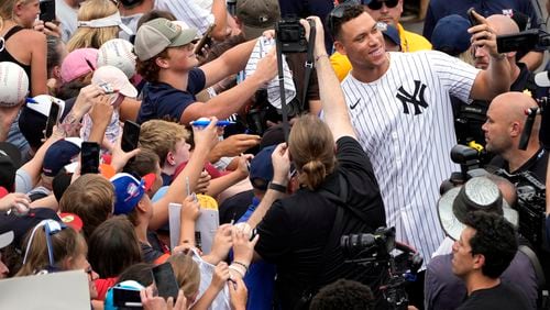 New York Yankees' Aaron Judge takes a selfie with a fan's cell phone as he arrives with the New York Yankees arrive at the Little League World Series Complex to watch the Little League World Series tournament in South Williamsport, Pa., Sunday, Aug. 18, 2024. (AP Photo/Tom E. Puskar)