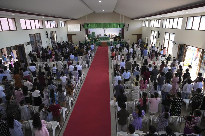 Parishioners attend a mass at a church in Dili, East Timor, Sunday, Aug. 11, 2024. (AP Photo/Achmad Ibrahim)