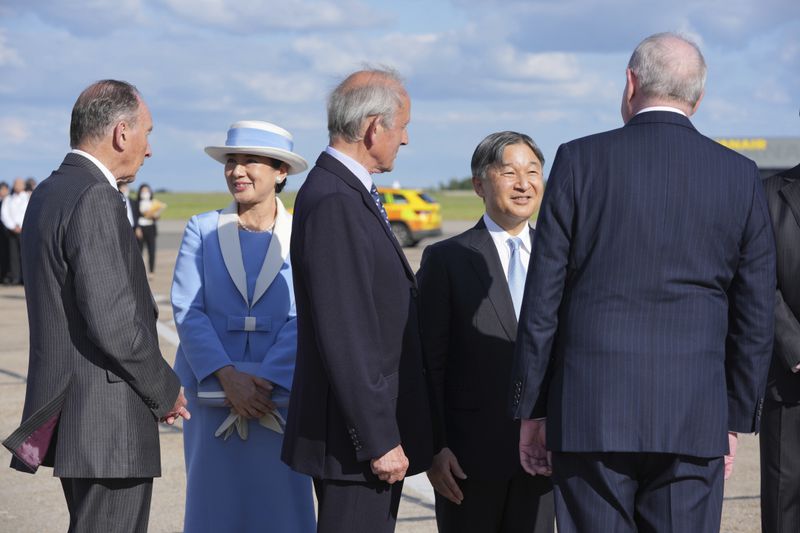 Emperor Naruhito and Empress Masako are greeted by dignitaries as they arrive at Stansted Airport, England, Saturday, June 22, 2024, ahead of a state visit. The state visit begins Tuesday, when King Charles III and Queen Camilla will formally welcome the Emperor and Empress before taking a ceremonial carriage ride to Buckingham Palace. (AP Photo/Kin Cheung)
