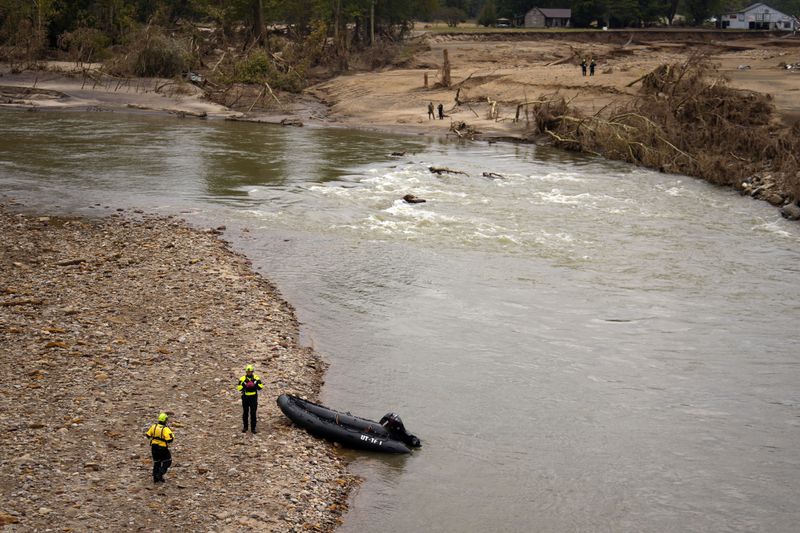 Personnel from Urban Search and Rescue Utah Task Force 1 work in the aftermath of Hurricane Helene, Friday, Oct. 4, 2024, in Erwin, Tenn. (AP Photo/Jeff Roberson)