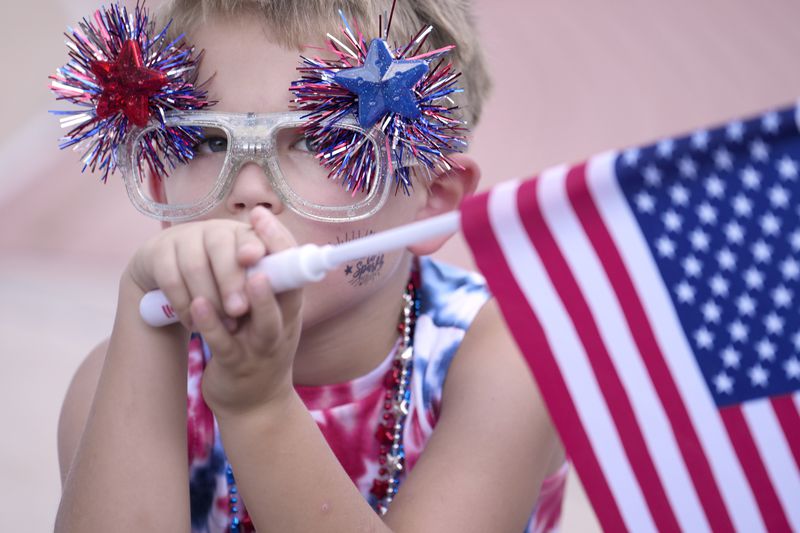 Sam Becker, 7, watches the annual South Montgomery County 4th of July Parade, Thursday, July 4, 2024, in The Woodlands, Texas. (Melissa Phillip/Houston Chronicle via AP)