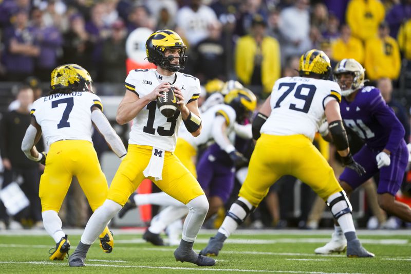 Michigan quarterback Jack Tuttle (13) looks to pass against Washington during the first half of an NCAA college football game Saturday, Oct. 5, 2024, in Seattle. (AP Photo/Lindsey Wasson)