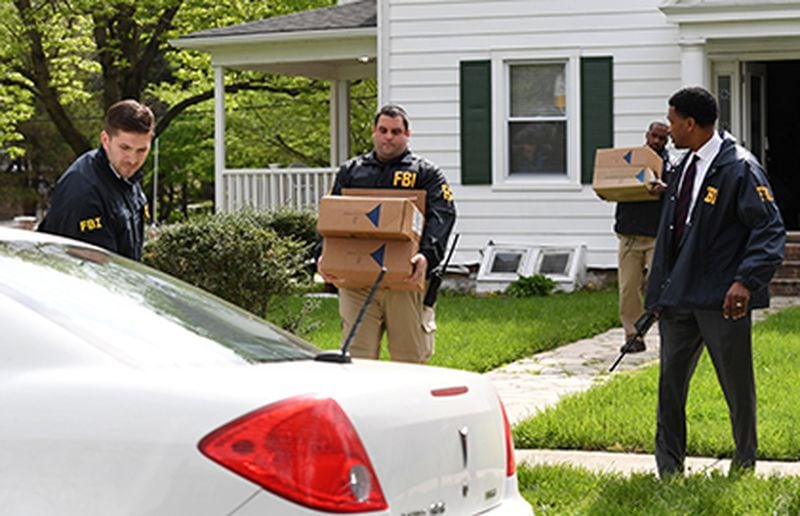 Federal agents remove items from the home of Baltimore Mayor Catherine Pugh, who resigned amid scandal.