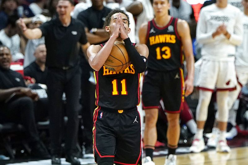 Atlanta Hawks guard Trae Young (11) reacts after bring fouled by Miami Heat forward P.J. Tucker during the second half of Game 2 of an NBA basketball first-round playoff series, Tuesday, April 19, 2022, in Miami. The Heat won 115-105. (AP Photo/Lynne Sladky)