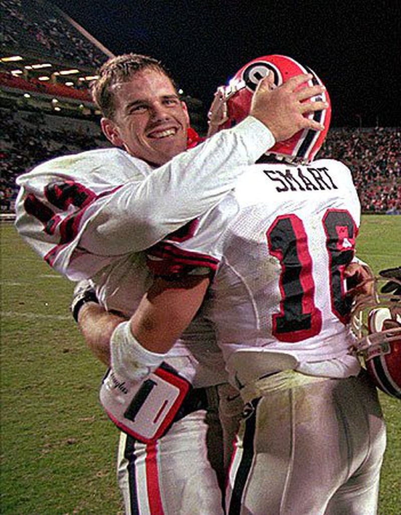 Georgia quarterback Mike Bobo (14) is congratulated by teammate Kirby Smart (16) following the Bulldogs' 56-49 overtime win over Auburn on Saturday, Nov. 16, 1996 at Jordan-Hare Stadium. Bobo led Georgia to four touchdowns in the overtime periods. (AP Photo/Karl Stolleis)