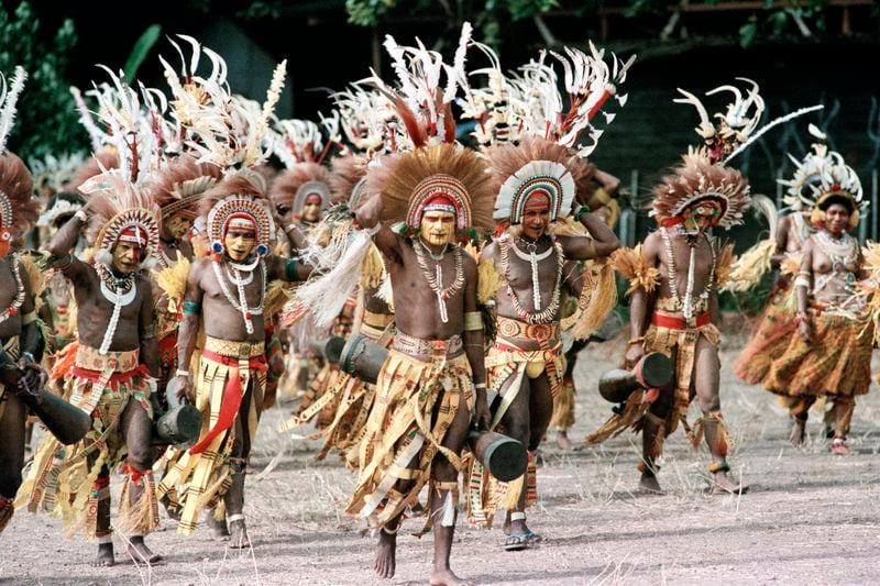 FILE - Painted warriors practice their performance on May 6, 1984, in Port Moresby, Papua New Guinea, before the arrival of Pope John Paul II. (AP Photo/Jeff Widener, File)