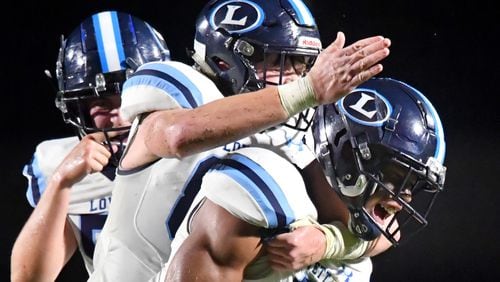 Lovett's Christian Bell (2) celebrates with teammates after he brought down Westminster's QB John Collier in the second half of their season opener game Friday, Aug. 20, 2021, at The Westminster Schools in Atlanta. Westminster won 17-7. (Hyosub Shin / Hyosub.Shin@ajc.com)