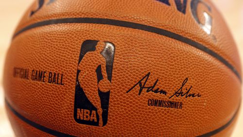 FILE - An NBA logo is seen on an official game ball before a basketball game, Feb. 1, 2014, in New York. The NBA said Wednesday, July 24, 2024, that it is not accepting Warner Bros. Discovery's $1.8 billion per year offer to continue its longtime relationship with the league and therefore has entered into a deal with Amazon Prime Video, a move that would mean this coming season would end a nearly four-decade run of games being on TNT. (AP Photo/Jason DeCrow, file)