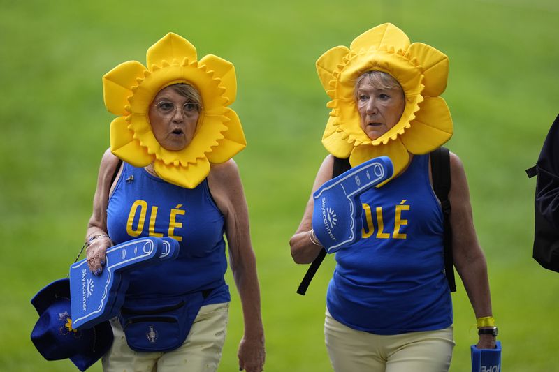 Fans are seen during a Solheim Cup golf tournament foursomes match at Robert Trent Jones Golf Club, Friday, Sept. 13, 2024, in Gainesville, VA. (AP Photo/Chris Szagalo)