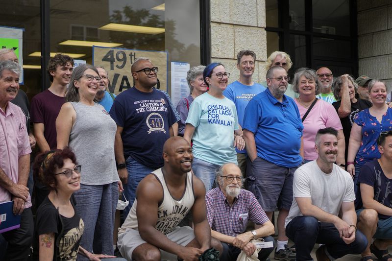 Illinois Rep. Kelly Cassidy, center, meets with volunteers as Democrats plan canvassing efforts in Wisconsin and Michigan as part of "Operation Swing State," Sunday, July 28, 2024, in Chicago. (AP Photo/Erin Hooley)