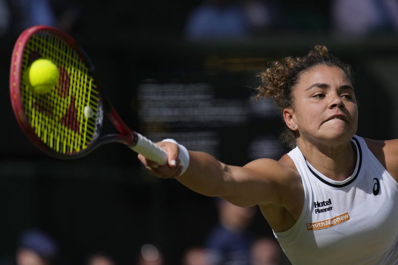 Jasmine Paolini of Italy plays a forehand return to Barbora Krejcikova of the Czech Republic during the women's singles final at the Wimbledon tennis championships in London, Saturday, July 13, 2024. (AP Photo/Mosa'ab Elshamy)