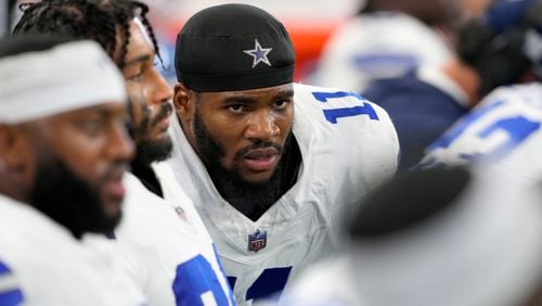 Dallas Cowboys linebacker Micah Parsons (11) sits on the bench alongside teammates in the second half of an NFL football game against the Baltimore Ravens in Arlington, Texas, Sunday, Sept. 22, 2024. (AP Photo/Jeffrey McWhorter)