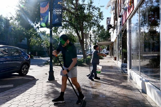 Amoz Costillo (front), owner of El Paso Tacos & Tequila, helped by Eluin Mianda cleans up to be ready to reopen his restaurant in downtown Valdosta, Saturday, September 28, 2024. Damaging Helene has swept through Georgia, leading to at least 15 deaths. All 159 counties are now assessing the devastation and working to rebuild, even as serious flooding risks linger. (Hyosub Shin / AJC)