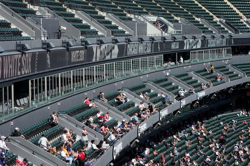 Fans watch the third inning of a baseball game between the Chicago White Sox and the Los Angeles Angels, Thursday, Sept. 26, 2024, in Chicago. (AP Photo/Charles Rex Arbogast)