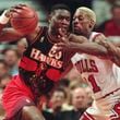 FILE - The Atlanta Hawks' Dikembe Mutombo, left, drives to the hoop against the Chicago Bulls' Dennis Rodman during the second quarter of their playoff game Thursday, May 8, 1997, in Chicago. (AP Photo/Michael S. Green, File)