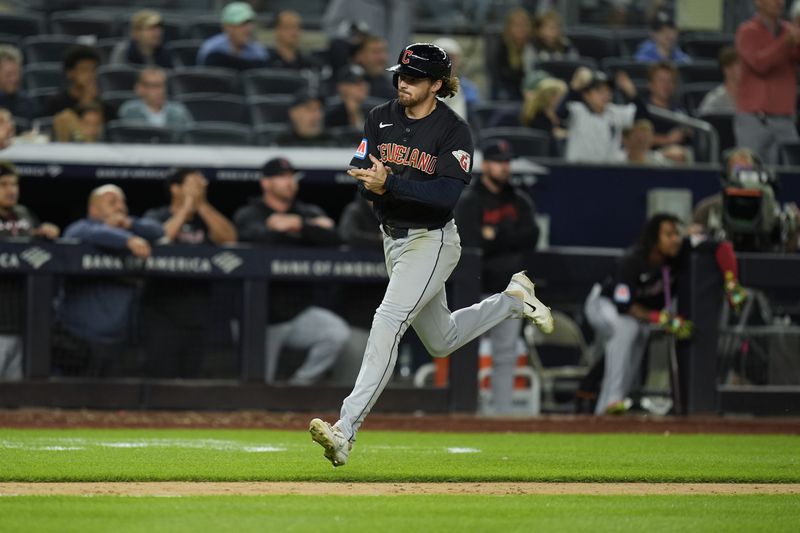 Cleveland Guardians' Daniel Schneemann celebrates as he scorers on a double hit by Lane Thomas during the 12th inning of a baseball game against the New York Yankees at Yankee Stadium Tuesday, Aug. 20, 2024, in New York. (AP Photo/Seth Wenig)